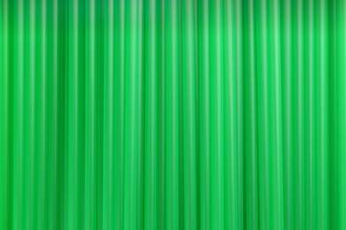 Photo of Heap of green plastic straws for drinks as background, closeup