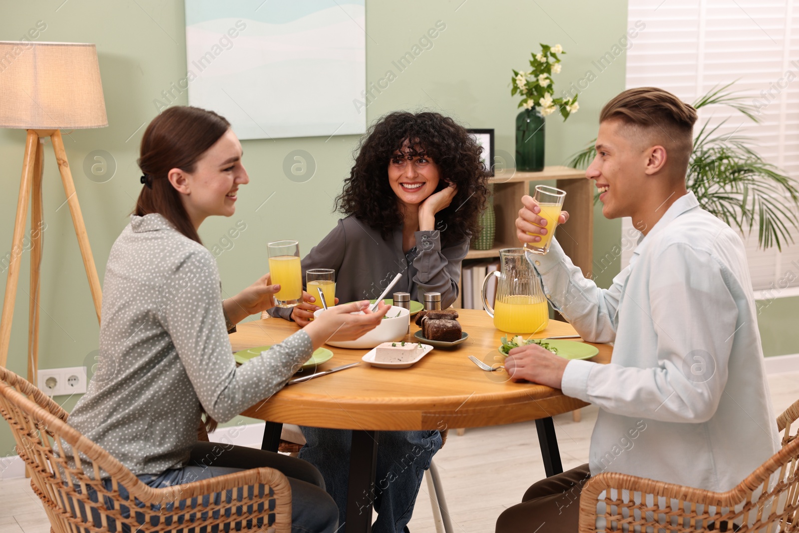 Photo of Happy friends having vegetarian meal in cafe