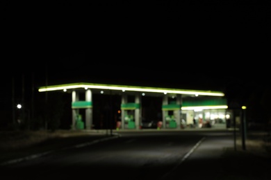 Photo of Blurred view of modern gas station at night outdoors