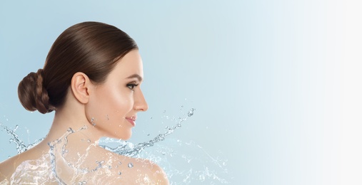Image of Beautiful young woman and splashing water on light background, space for text. Spa portrait