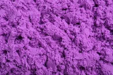 Photo of Violet kinetic sand as background, closeup view