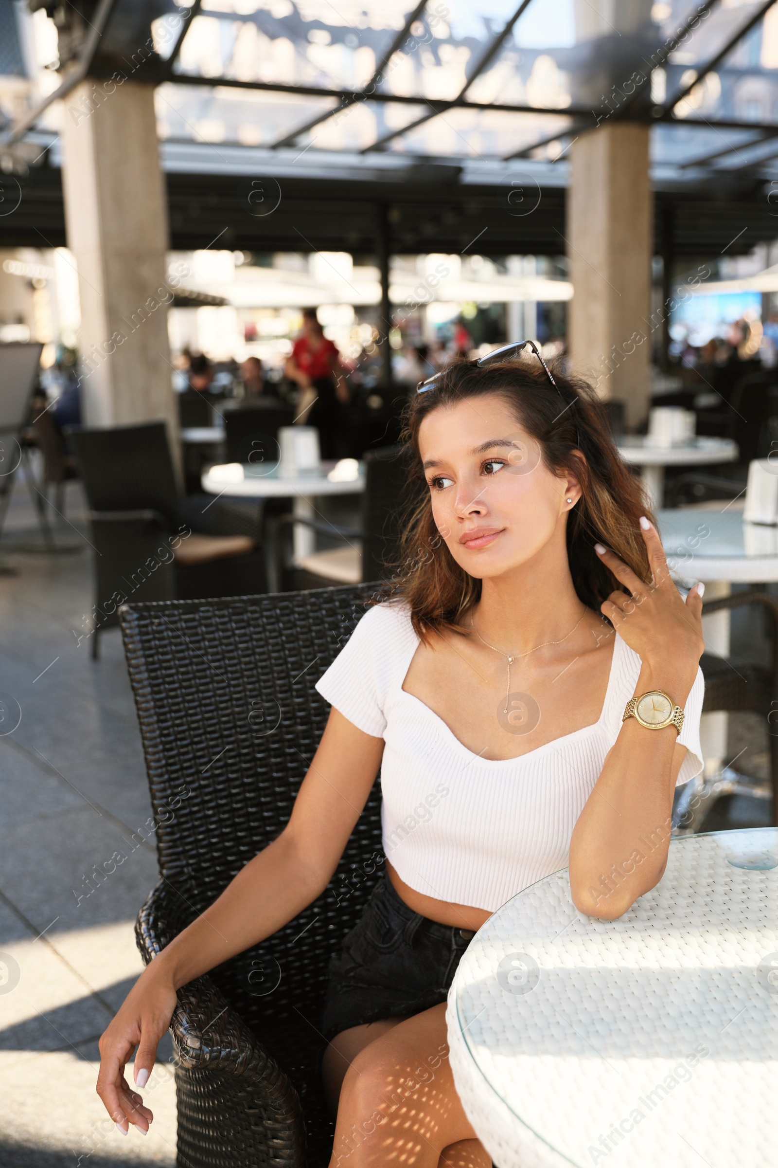 Photo of Portrait of beautiful young woman in outdoor cafe