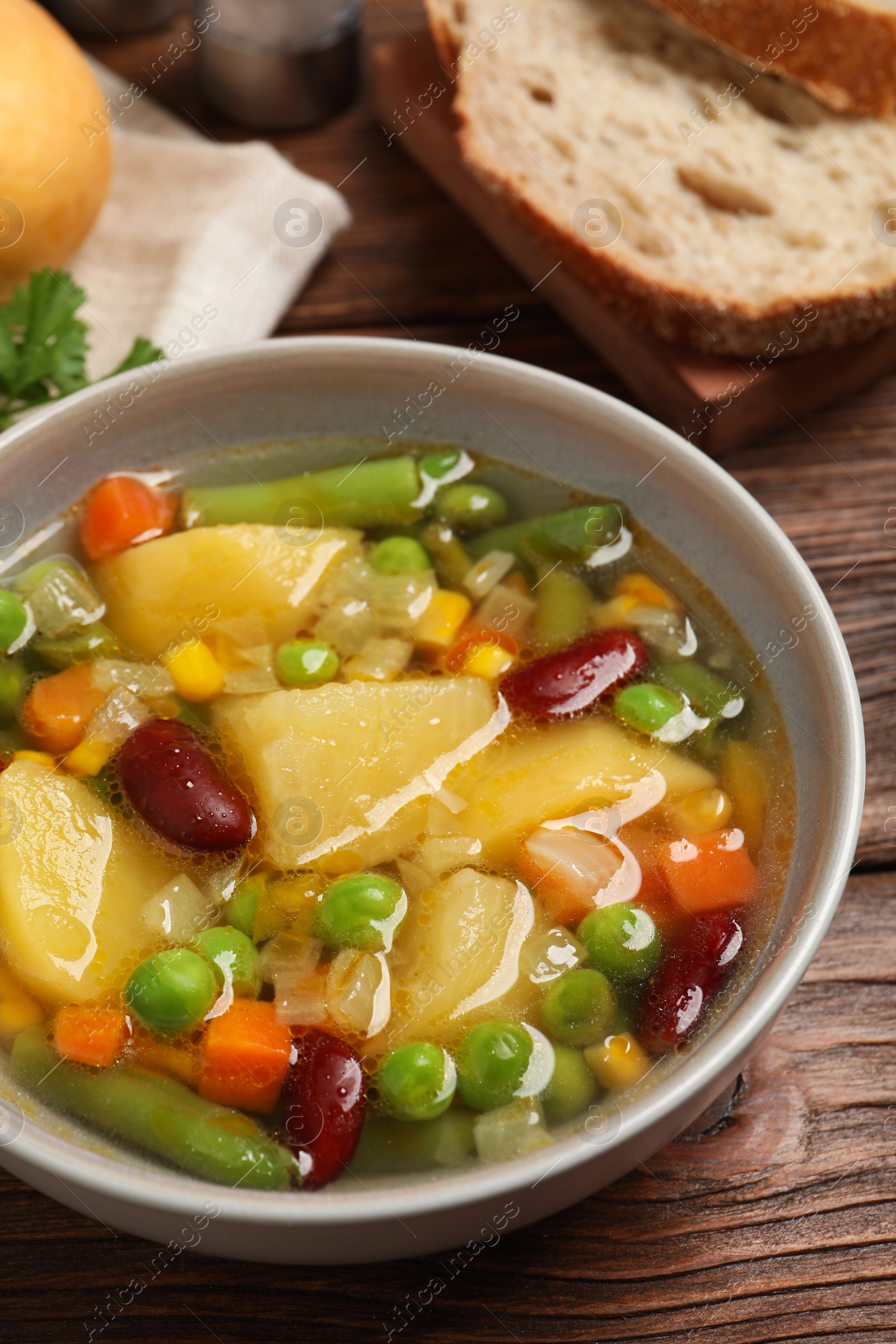 Photo of Bowl of delicious turnip soup on wooden table