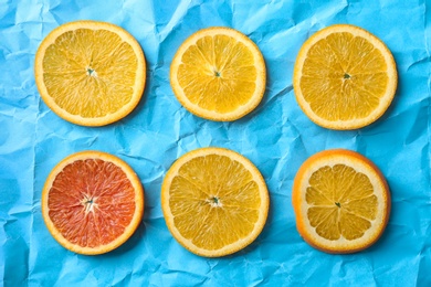 Fresh yummy citrus slices on color background