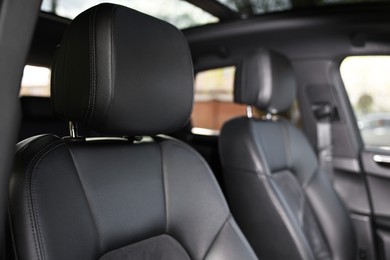 Seats inside of modern black car, closeup view