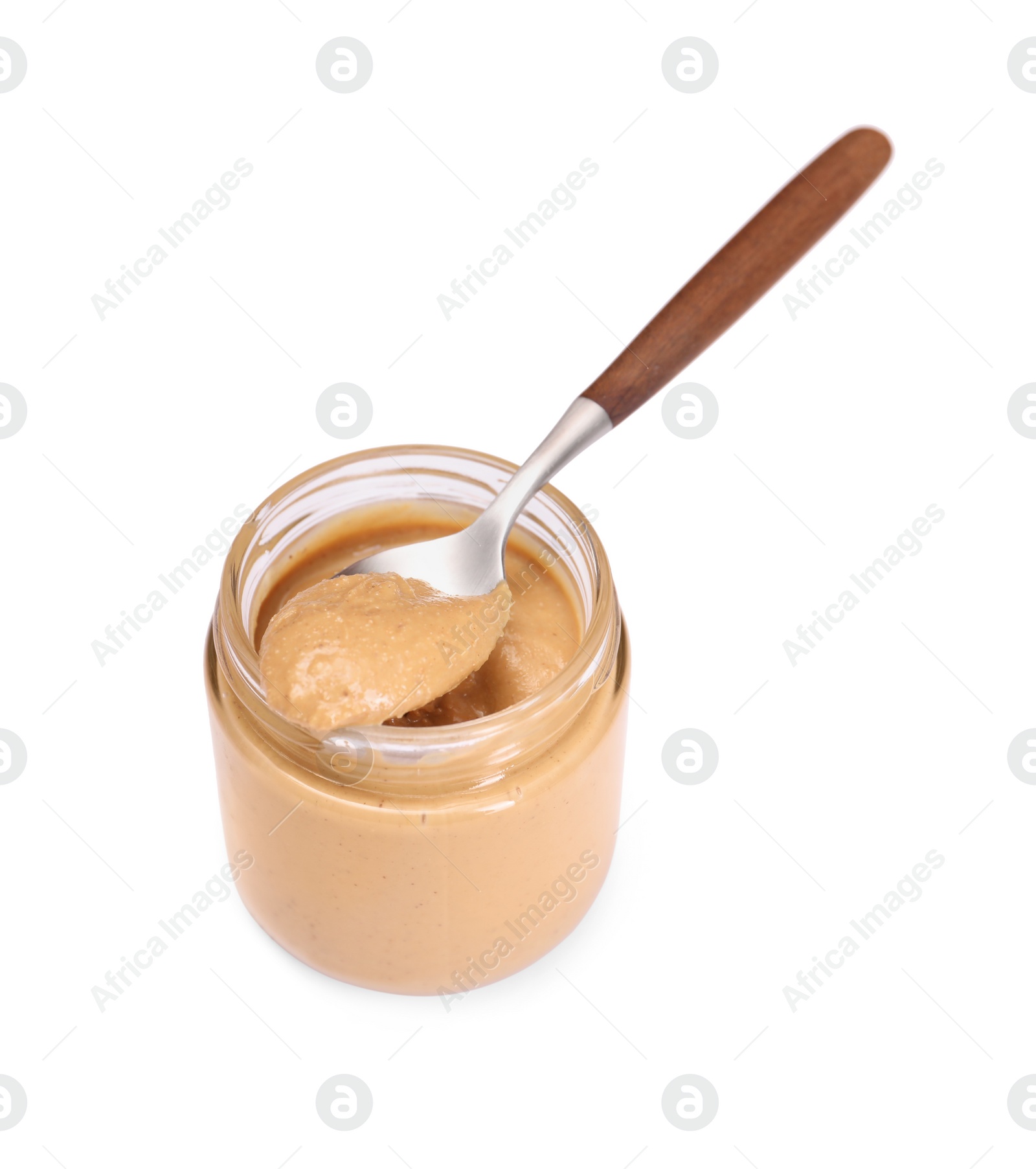 Photo of Tasty nut paste in jar and spoon isolated on white