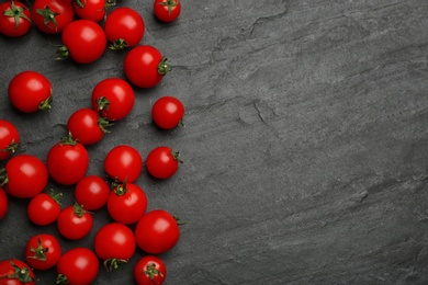 Photo of Fresh ripe cherry tomatoes on black table, flat lay. Space for text