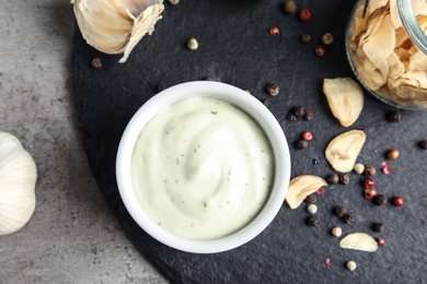 Photo of Flat lay composition with garlic sauce on grey background