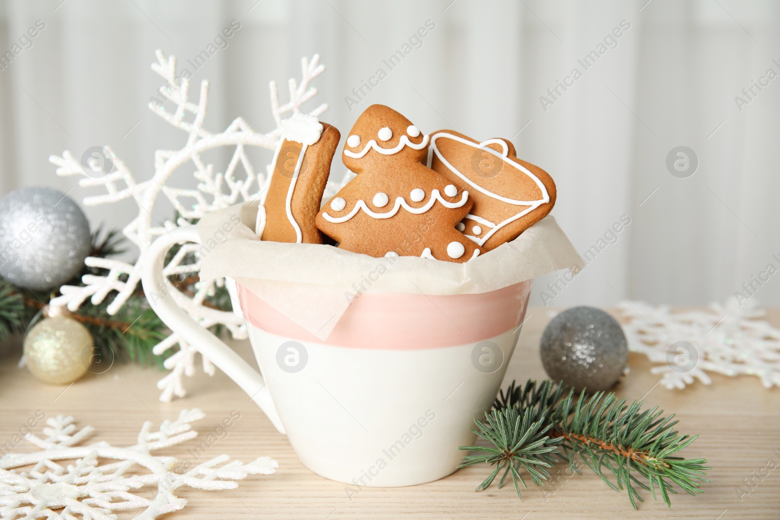 Photo of Cup with tasty homemade Christmas cookies on table