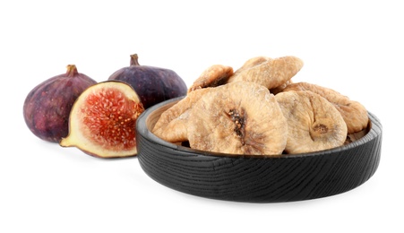 Photo of Black wooden plate of dried figs and fresh fruits on white background