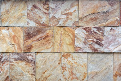 Photo of Wall with marble stone tiles as background, closeup