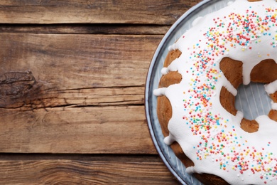 Glazed Easter cake with sprinkles on wooden table, top view. Space for text