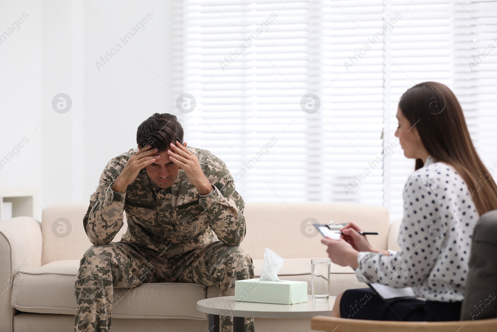 Photo of Psychotherapist working with male military officer in office