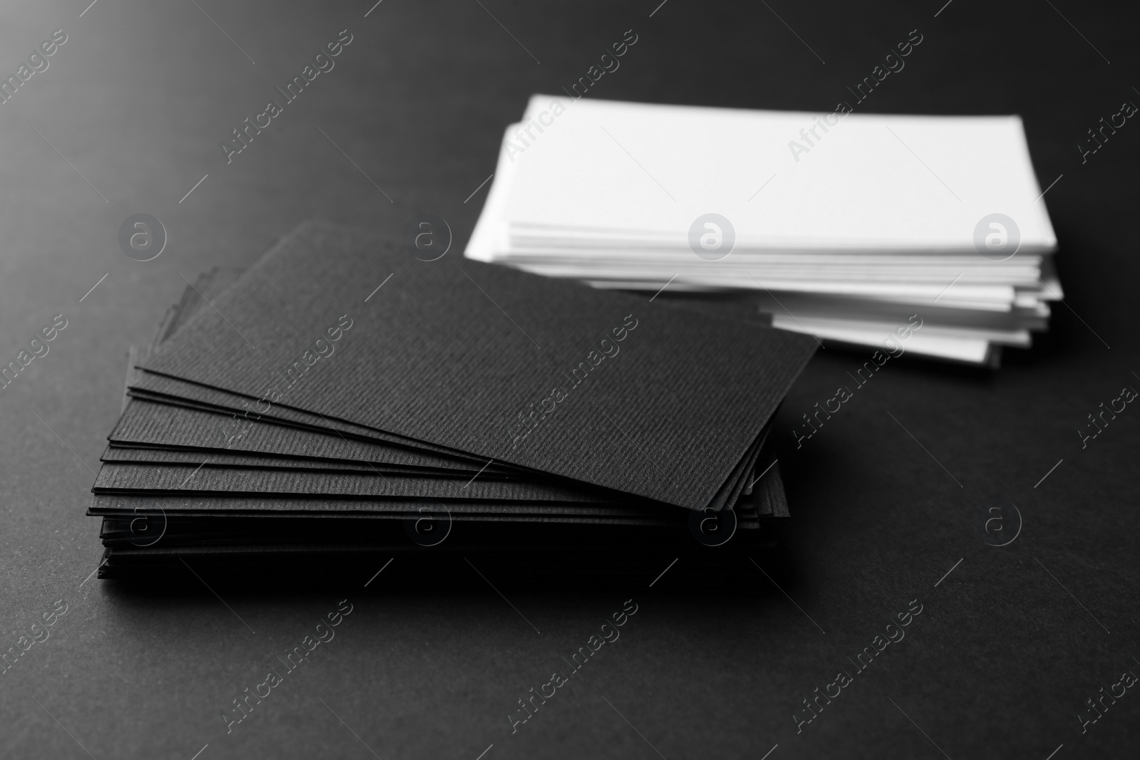 Photo of Many business cards on black background, closeup. Mockup for design