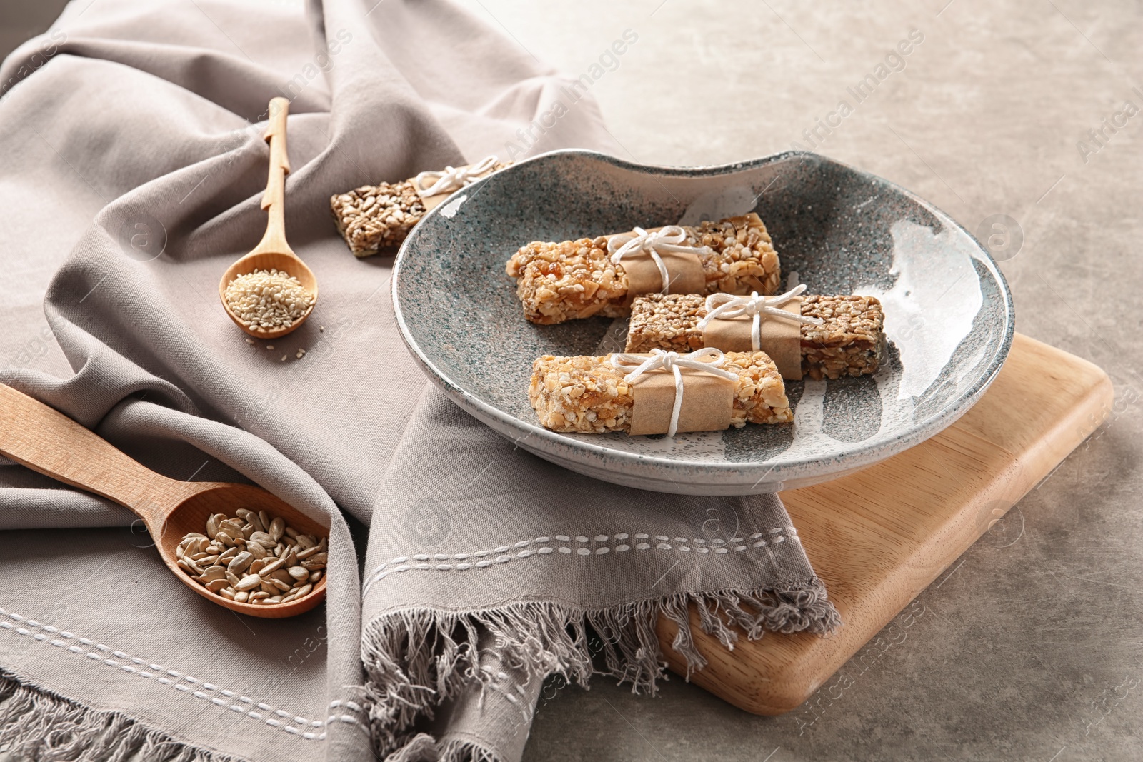 Photo of Plate with different homemade grain cereal bars on table. Healthy snack