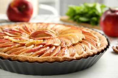 Photo of Delicious homemade apple tart on white wooden table, closeup