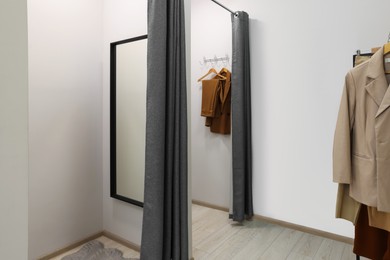 Photo of Dressing rooms in fashion store. Interior design