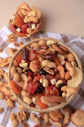 Photo of Mixed dried fruits and nuts on beige background, flat lay