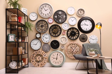 Stylish room interior with collection of wall clocks