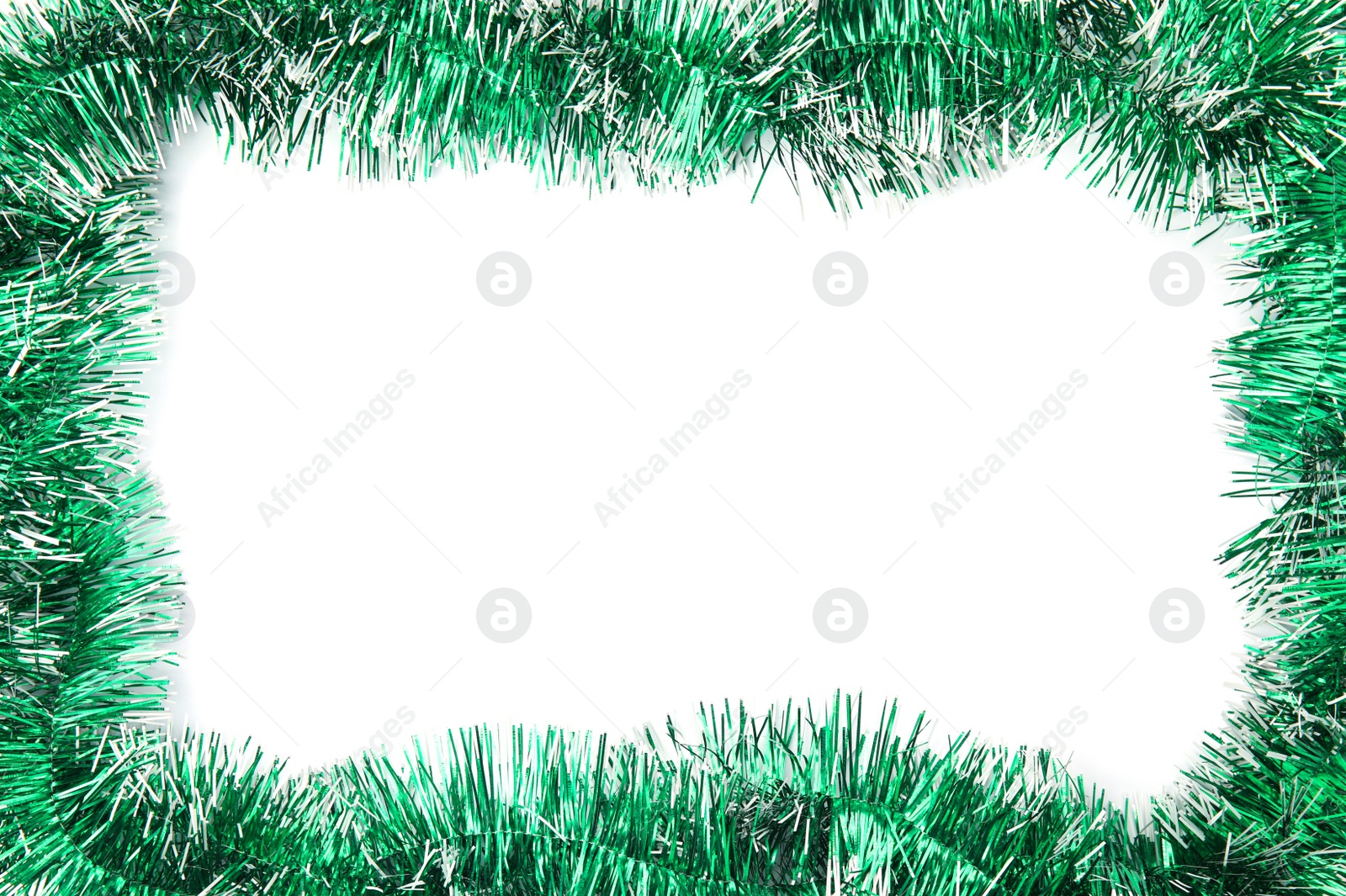 Photo of Frame of shiny green tinsel on white background, top view. Space for text