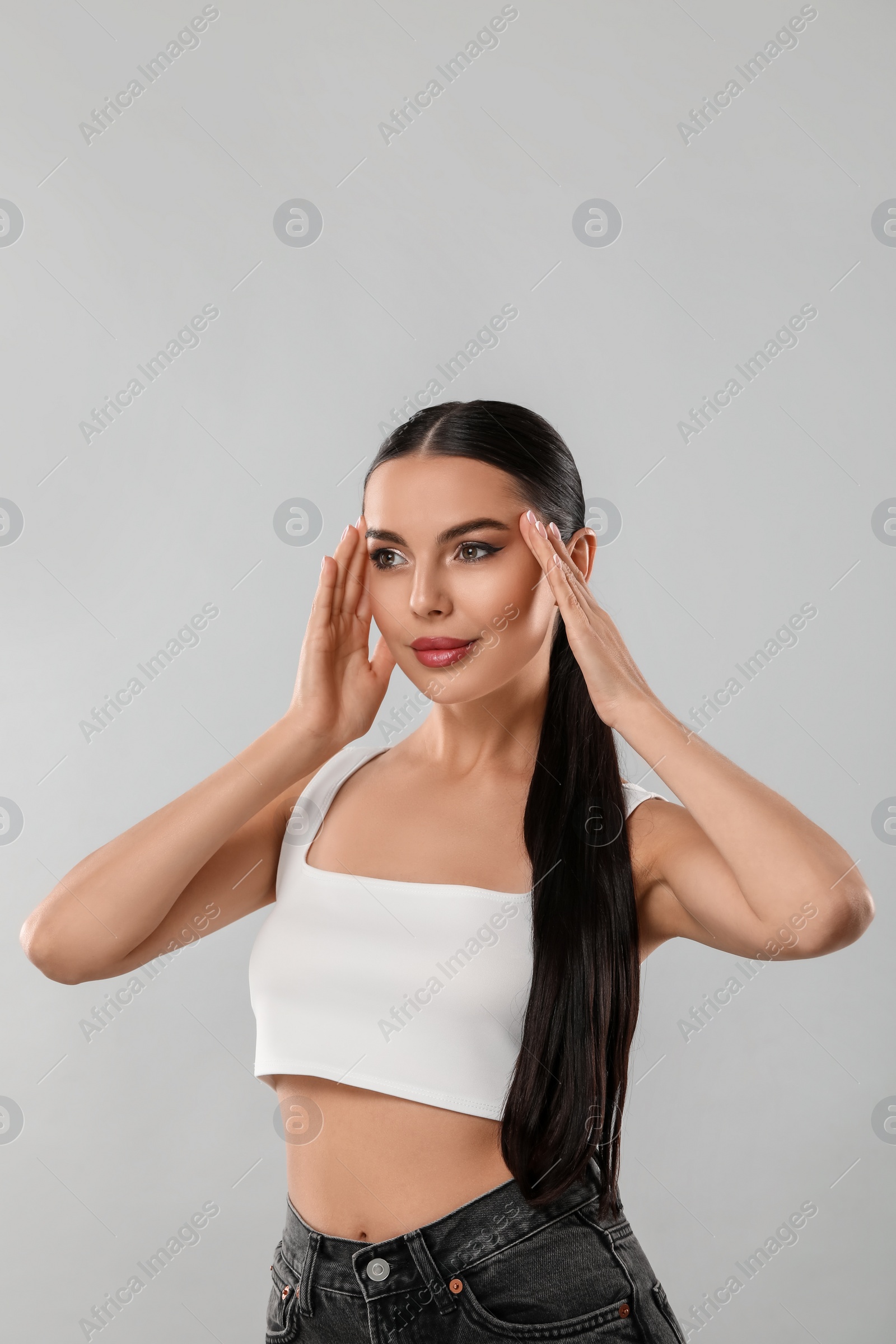 Photo of Beautiful woman wearing makeup on light grey background