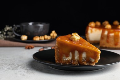 Photo of Piece of delicious cake with caramel and popcorn on light grey table, space for text