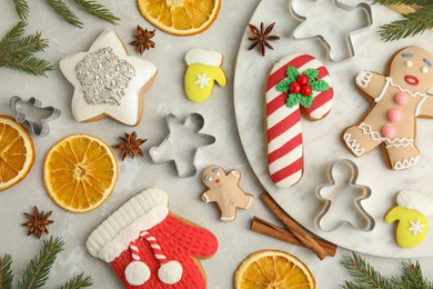 Photo of Flat lay composition with decorated Christmas biscuits and cookie cutters on light table