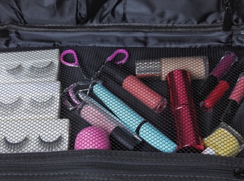 Photo of Stylish case with makeup products and beauty accessories, closeup