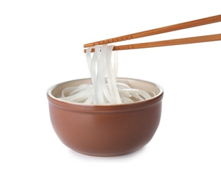 Photo of Bowl of cooked rice noodles and chopsticks isolated on white