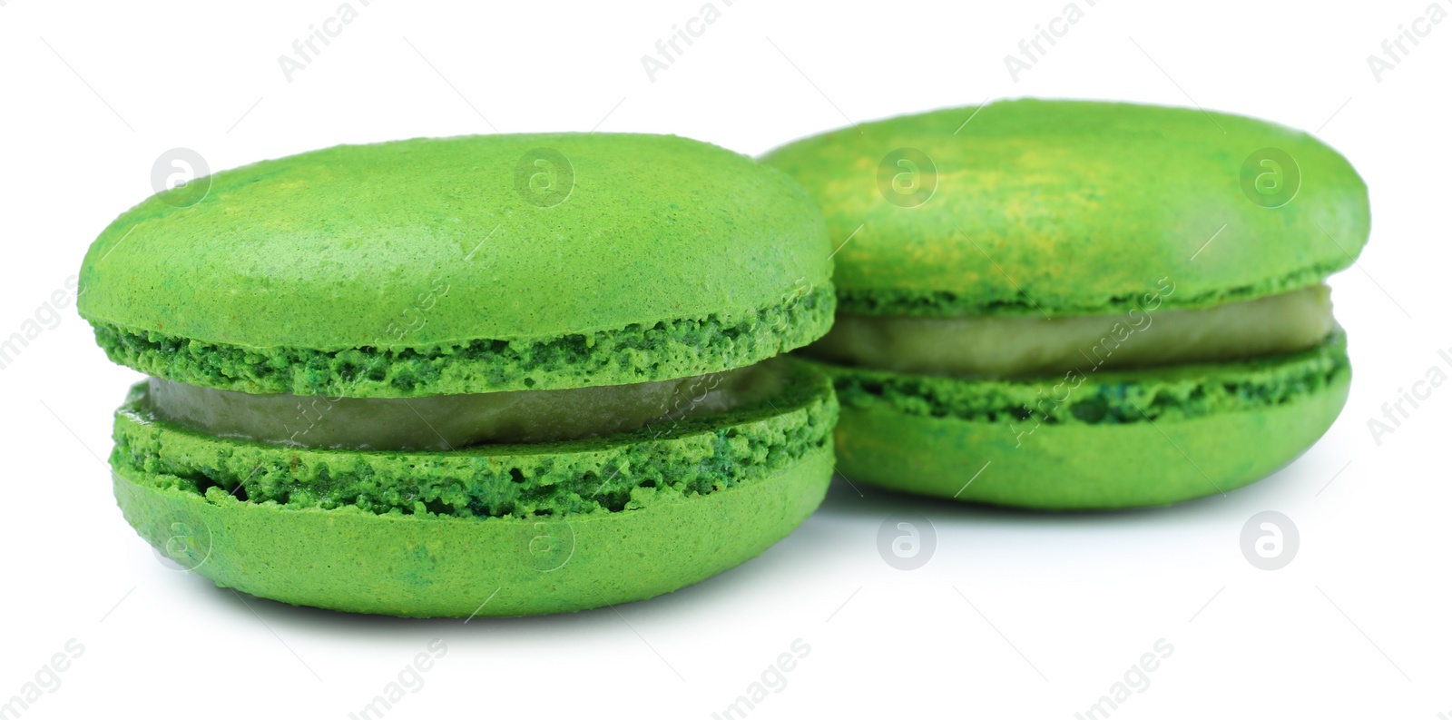 Photo of Green macarons on white background. Delicious dessert