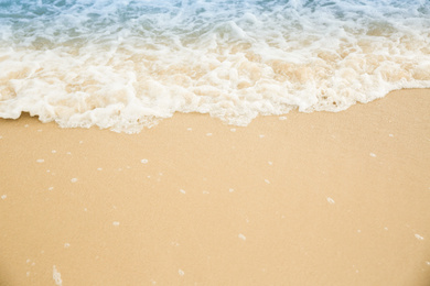 Photo of Sea waves rolling on beautiful sandy beach. Summer vacation