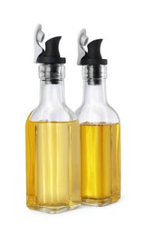 Glass bottles with cooking oil on white background