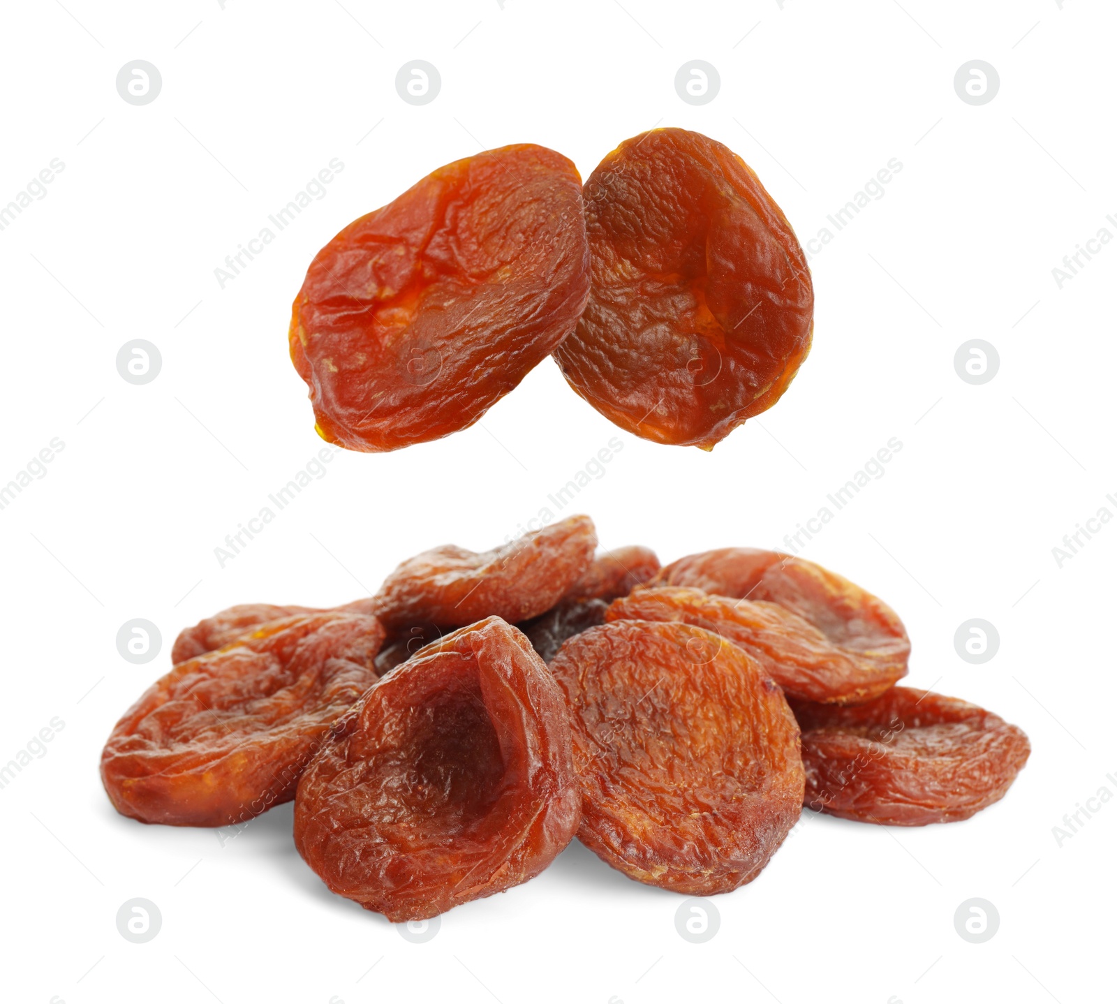 Image of Tasty dried apricots falling on white background