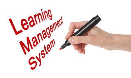 Image of Woman writing Learning Management System on white board, closeup