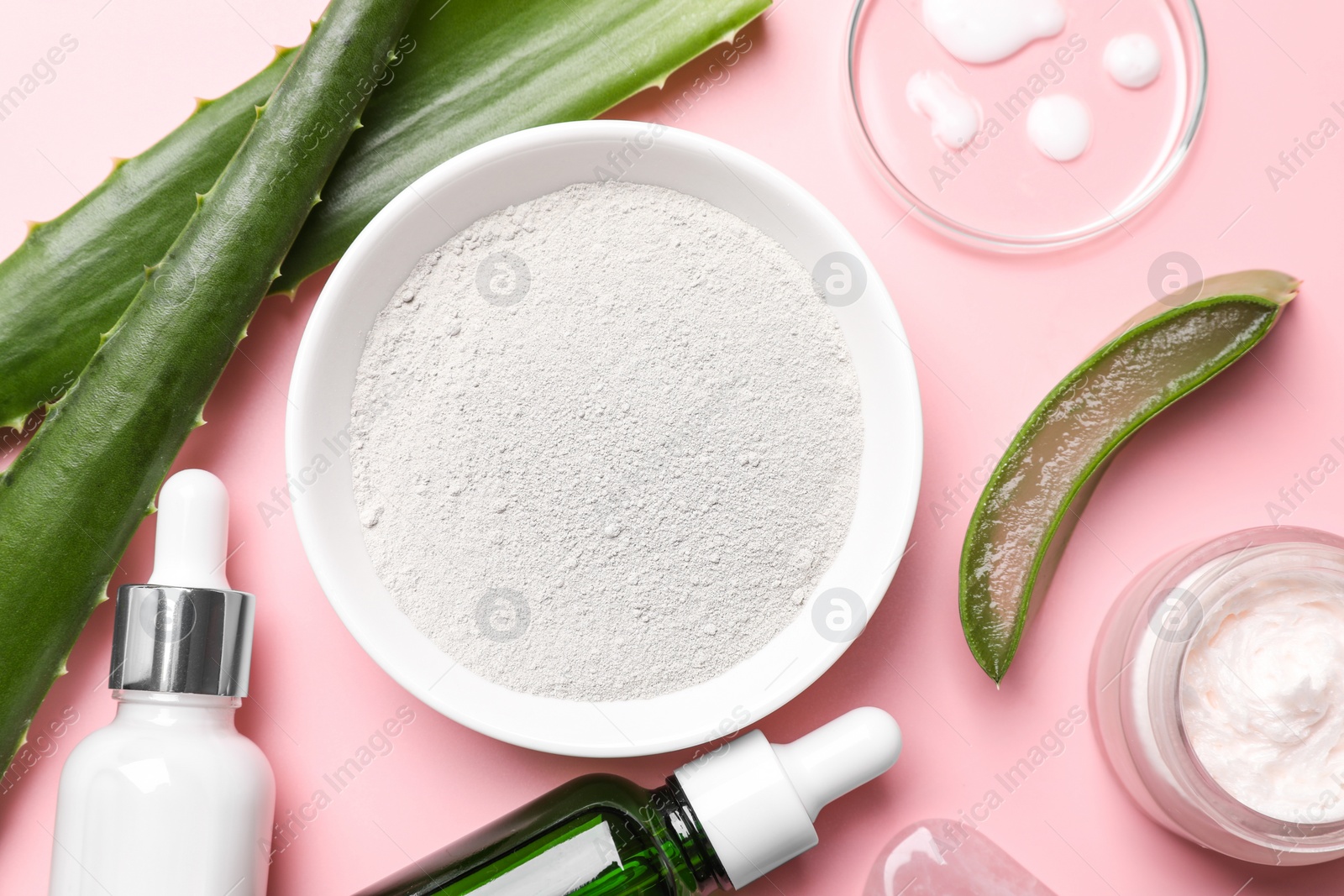 Photo of Flat lay composition with cosmetic products and cut aloe leaves on pink background