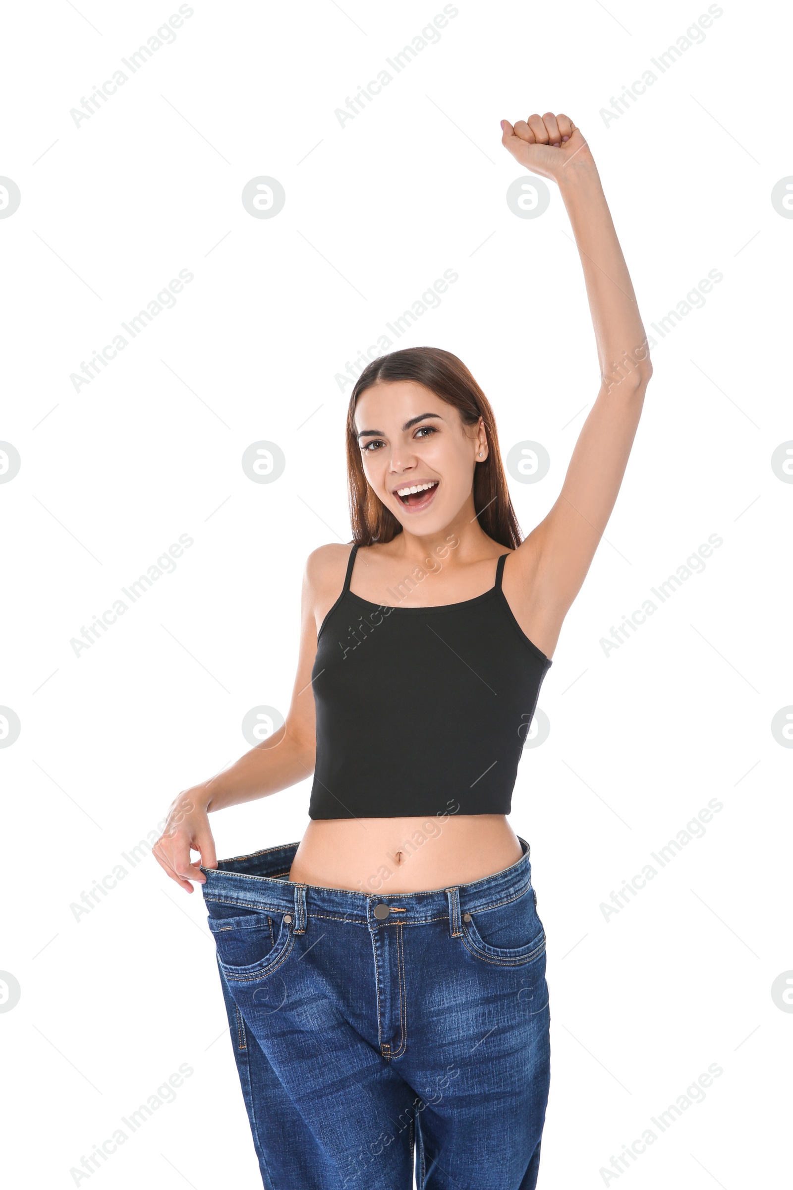 Photo of Slim woman in oversized jeans on white background. Weight loss