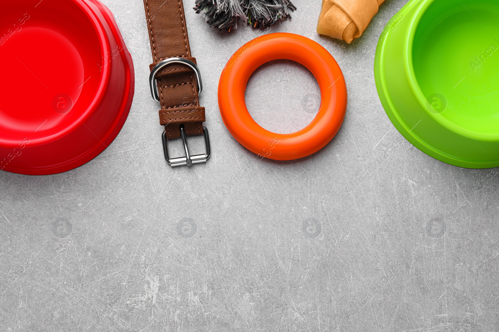 Photo of Flat lay composition with dog collar and different accessories on light grey table, space for text