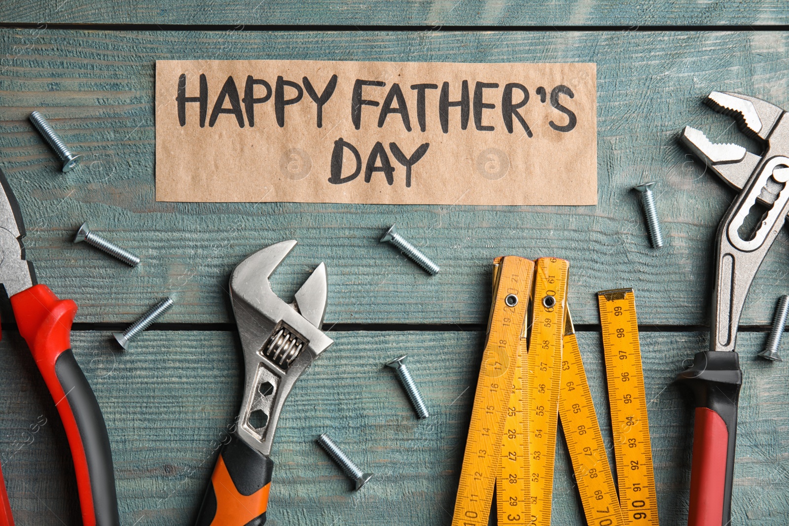 Photo of Flat lay composition with different tools on blue wooden background. Happy Father's Day