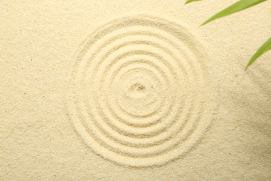 Photo of Zen rock garden. Circle pattern on beige sand, top view