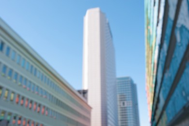 Blurred view of modern buildings on sunny day