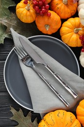 Photo of Happy Thanksgiving day. Beautiful table setting with autumn leaves, berries and pumpkins, flat lay