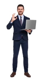 Handsome bearded businessman in suit with laptop showing OK gesture on white background