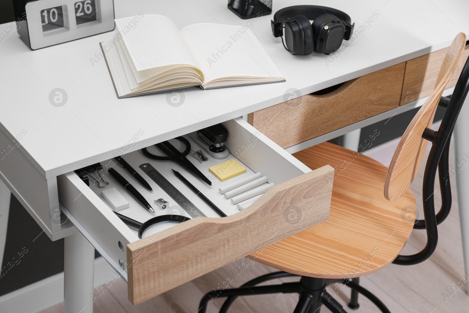 Photo of Office supplies in open desk drawer indoors