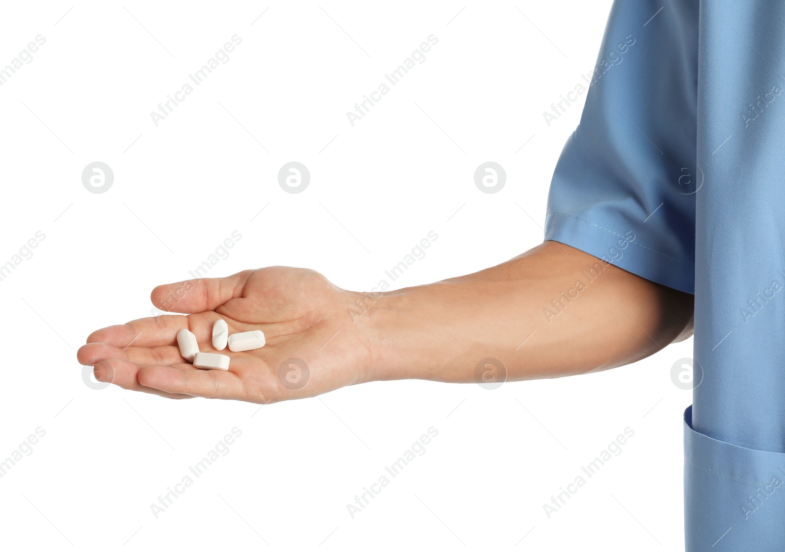 Photo of Male doctor holding pills on white background, closeup. Medical object