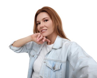 Beautiful woman taking selfie on white background