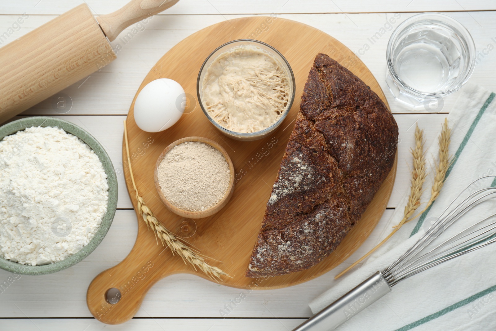 Photo of Flat lay composition with sourdough on white wooden table