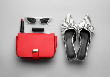 Flat lay composition with stylish woman's bag on light background