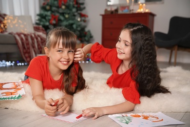 Photo of Little children with drawings and letter to Santa at home. Christmas celebration