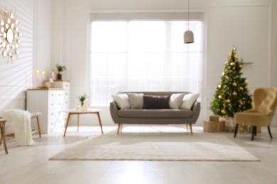 Photo of Blurred view of beautiful living room interior with Christmas tree