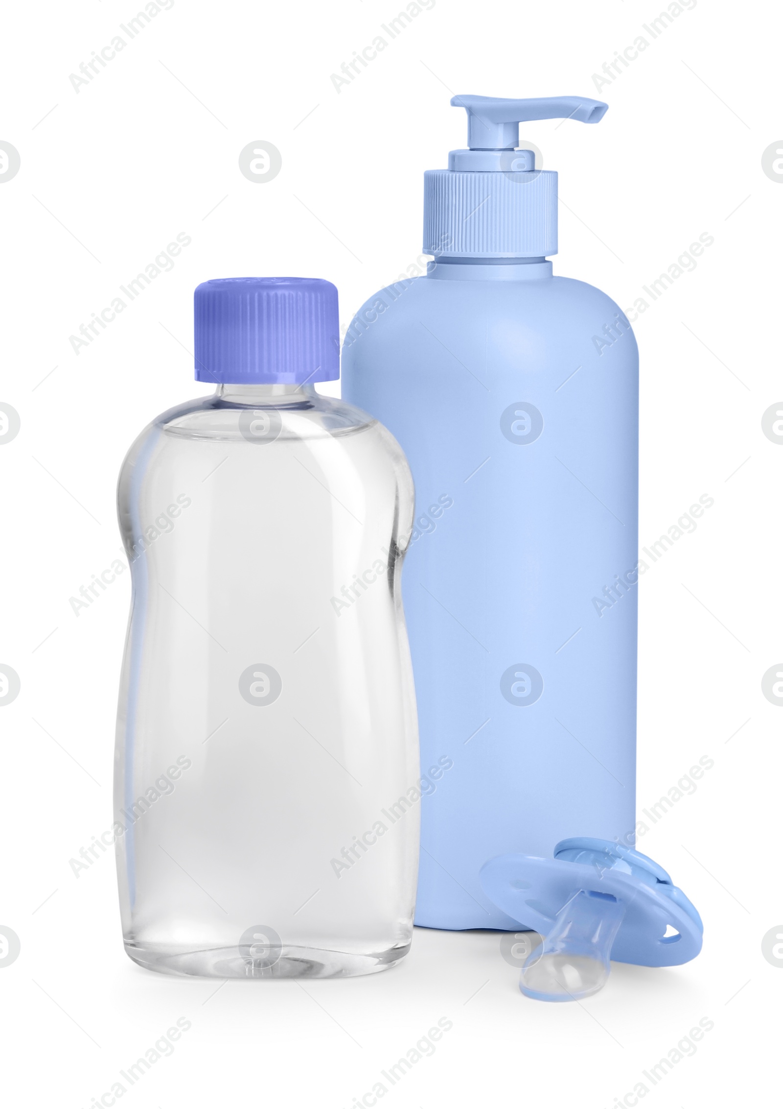 Photo of Pacifier, baby oil and lotion in bottles isolated on white